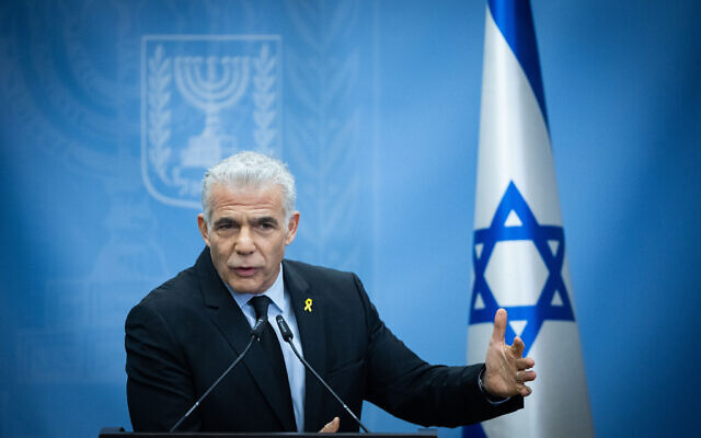 Opposition Leader Yair Lapid leads a Yesh Atid party faction meeting at the Knesset, in Jerusalem, on December 25, 2023. (Yonatan Sindel/Flash90)