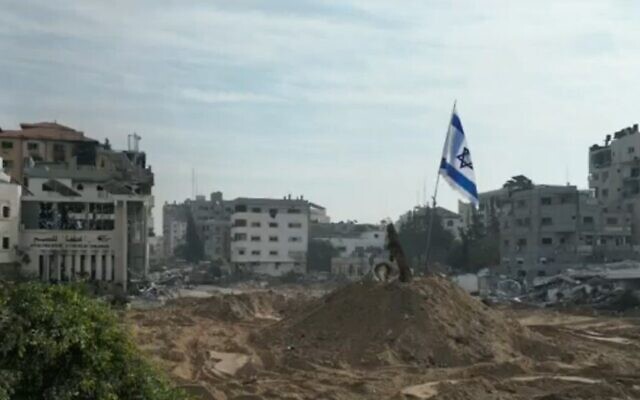 The Israeli flag flies in Gaza City's Palestine Square, in footage broadcast by Channel 12 on December 9, 2023 (Screenshot used in accordance with Clause 27a of the Copyright Law)