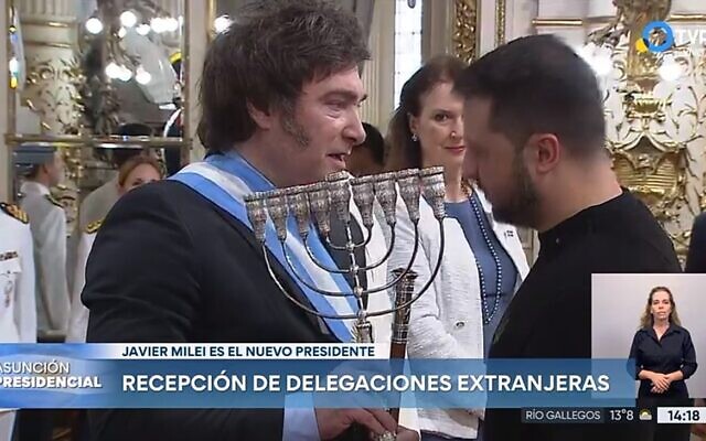Argentina's Javier Milei hands a Hanukkah menorah to Ukraine's Volodymyr Zelensky during Milei's inaugural ceremonies in Buenos Aires, Dec. 10, 2023. (Screenshot from Argentinean national TV broadcast via JTA)