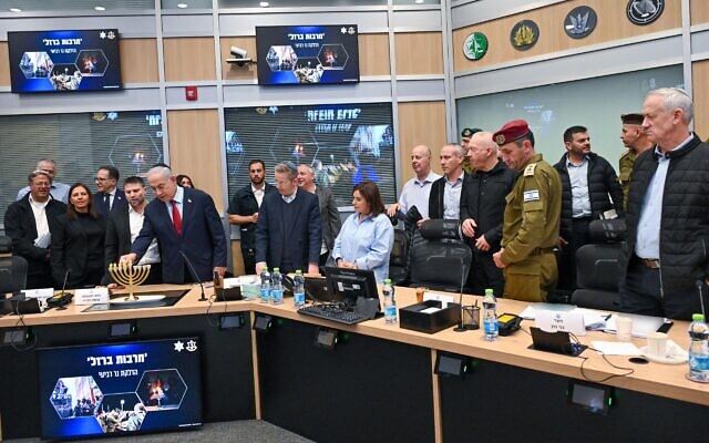 Prime Minister Benjamin Netanyahu lights Hanukkah candles at the start of a security cabinet meeting in Tel Aviv on December 10, 2023. (Kobi Gideon/GPO)