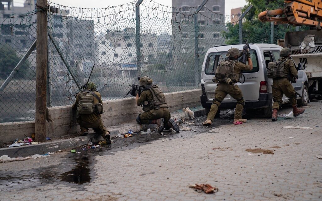Troops of the Nahal Infantry Brigade's 931st Battalion battle Hamas operatives in northern Gaza’s Jabaliya, in a handout image published December 9, 2023. (Israel Defense Forces)
