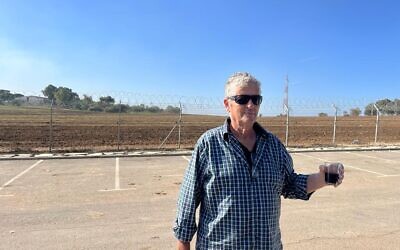 Ami Rabin at the perimeter fence of his Kibbutz Nir Am, southern Israel, on November 30, 2023. (Canaan Lidor/Times of Israel)