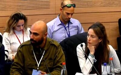 Reservist Lior Moshayev (L) testifies before the Knesset's Finance Committee on December 25, 2023 (video screenshot; used in accordance with Clause 27a of the Copyright Law)