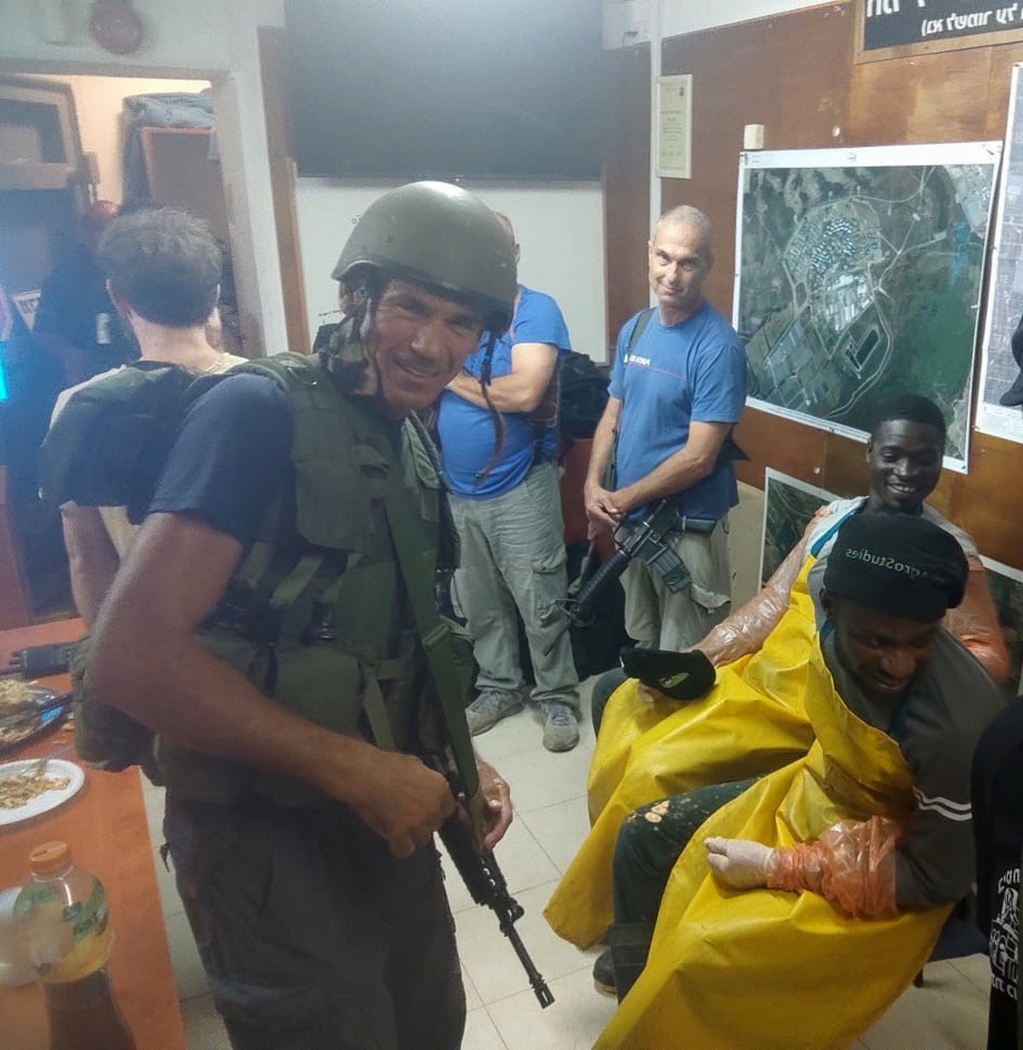 Gabo Altmark (in the blue shirt) along with other members of the Zikim civil guard and agricultural interns inside a safe room during a rocket alert. (Kwabena Frimpong)