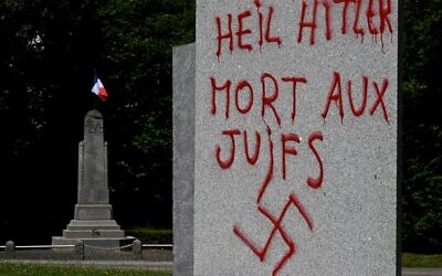 Illustrative: This picture taken on July 17, 2023 shows a graffito in German and French reading 'Hail Hitler, death to Jews' and with a swastika, on a monument in memory of 55 people executed at this site by the Nazis in 1944 during World War II, in Ploeuc-L'Hermitage, some 20km south of Saint-Brieuc, western France. (Photo by Damien MEYER / AFP)