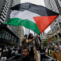 Anti-Israeli demonstrators wave Palestinian flags during a protest in Toronto, Ontario, Canada, October 9, 2023. (Cole Burston / AFP)