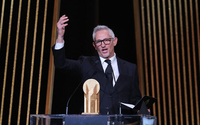 File: Gary Lineker, former English footballer turned sports TV presenter, gestures on stage with the Gerd Muller Trophy for best striker during the 2023 Ballon d'Or France Football award ceremony at the Theatre du Chatelet in Paris on October 30, 2023. (FRANCK FIFE / AFP)