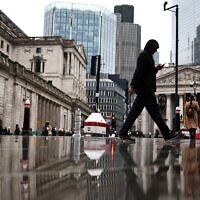 Illustrative: People walk by the Bank of England building (L) and Stock Exchange building (R), in the financial district, central London, on November 2, 2023. (HENRY NICHOLLS / AFP)
