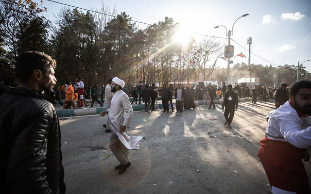People disperse near the site where two explosions in quick succession struck a crowd marking the anniversary of the 2020 killing of Guards general Qasem Soleimani, near the Saheb al-Zaman Mosque in the southern Iranian city of Kerman on January 3, 2024. (Mehr News/AFP)