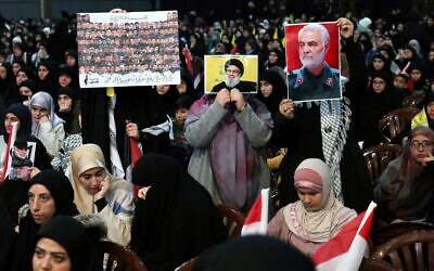 Supporters hold portrait of Lebanon's Hezbollah chief Hassan Nasrallah, center, and of slain Iranian commander Qassem Soleimani, right, during the commemorations of the anniversary of his killing in a Beirut's southern suburb on January 3, 2024. (ANWAR AMRO / AFP)