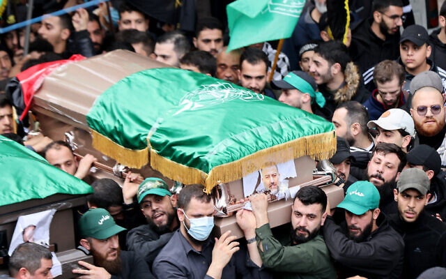 Mourners carry the coffin of Hamas' terror chief Saleh al-Arouri during his funeral procession in Lebanon's capital on January 4, 2024. (ANWAR AMRO / AFP)
