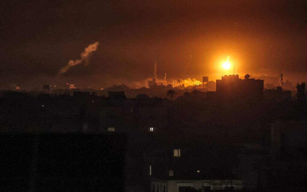 An Israeli airstrike light the skyline of Khan Yunis, pictured from Rafah in the southern Gaza Strip late on January 7, 2024 (Photo by AFP)