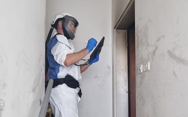 Investigators at the scene of a fire in an apartment in Tel Aviv on January 18, 2024. (Israel Police)