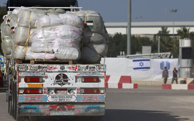 An Egyptian truck carrying humanitarian aid undergoes security checks at the Israeli side of the Kerem Shalom border crossing before entering the southern Gaza Strip, on January 22, 2024. (Menahem KAHANA / AFP)