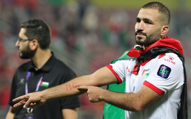 File: The Palestinian national soccer team's midfielder (#06) Oday Kharoub points to the number 110 on his hand, as he displays support with the people of Gaza, during the Qatar 2023 AFC Asian Cup Group C football match between Hong Kong and Palestine at the Abdullah bin Khalifa Stadium in Doha on January 23, 2024. (Giuseppe Cacace/AFP)