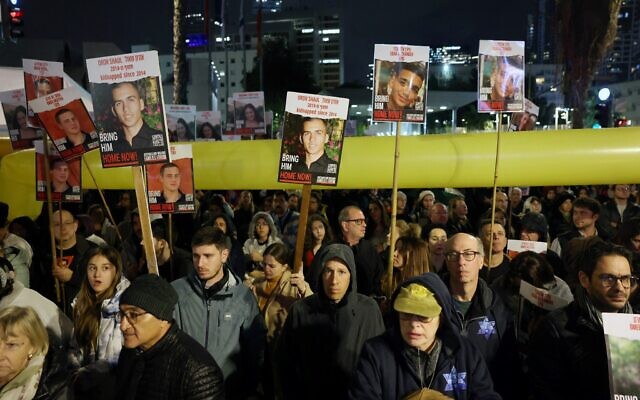 Relatives and supporters hold placards bearing portraits of Israeli hostages held in Gaza since the October 7 attacks by Hamas in southern Israel, during a rally calling for their release, in Tel Aviv on January 27, 2024. (AHMAD GHARABLI / AFP)