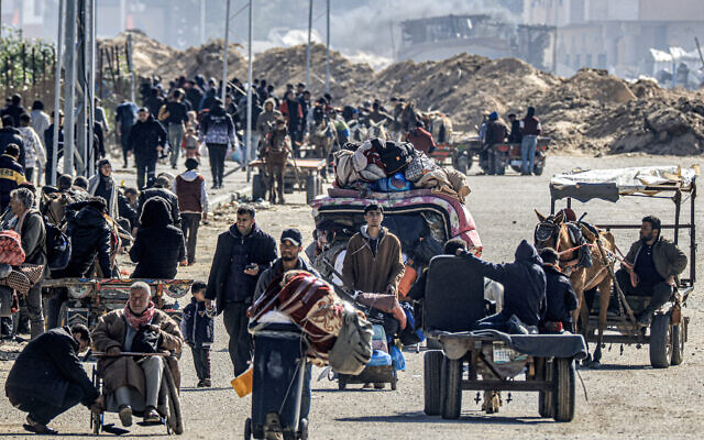 Displaced Palestinians flee from Khan Younis in the southern Gaza Strip on January 30, 2024. (Mahmud Hams/AFP)