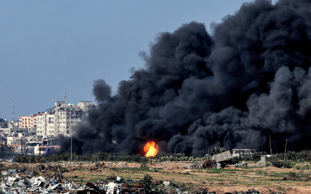 An explosion erupts as a dark smoke plume rises in the Gaza Strip during the ongoing war between Israel and the Palestinian terror group Hamas on January 31, 2024. (Jack Guez/AFP)