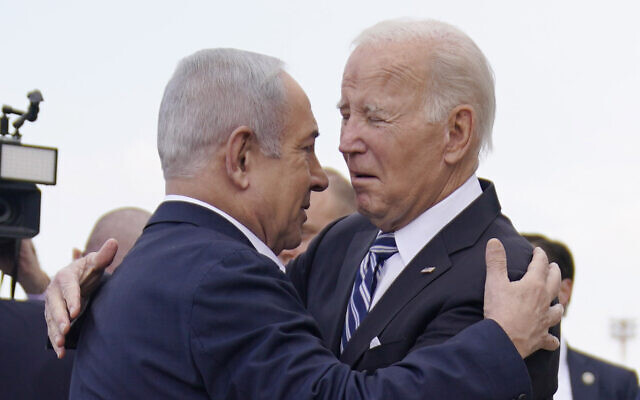 US President Joe Biden (right) is greeted by Prime Minister Benjamin Netanyahu at Ben Gurion International Airport, October 18, 2023. (Evan Vucci/AP)