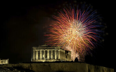 Fireworks explode over the ancient Parthenon temple at the Acropolis hill during New Year's celebrations in Athens, Greece, Monday, Jan. 1, 2024. (AP Photo/Yorgos Karahalis)