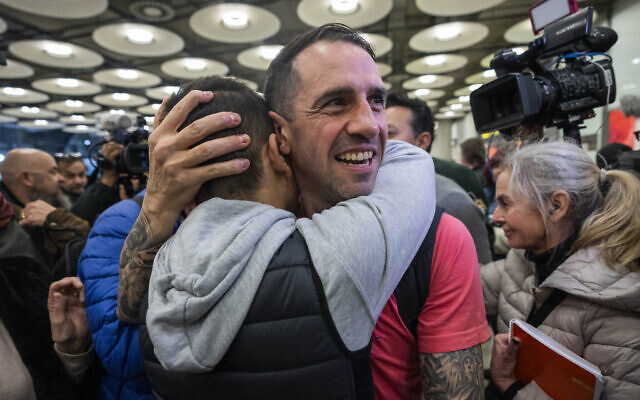 Spanish Santiago Sanchez Cogedor is welcomed by friends and family members at the Barajas airport, outskirts of Madrid, Tuesday, Jan. 2, 2024. (AP Photo/Bernat Armangue)