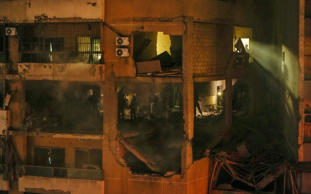 People search for survivors inside an apartment following a massive explosion in the southern suburb of Beirut, Lebanon, on Tuesday, January 2, 2024, in which Hamas deputy leader Saleh al-Arouri was killed. (AP Photo/Hassan Ammar)