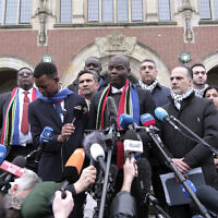 South Africa's Minister of Justice and Correctional Services Ronald Lamola, center, and Palestinian Assistant Minister of Multilateral Affairs Ammar Hijazi, third right, address the media outside the International Court of Justice in The Hague, Netherlands, January 11, 2024. (AP/Patrick Post)