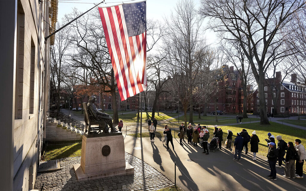 File: People take photos near a John Harvard statue, left, on the Harvard University campus in Cambridge, Massachusetts, January 10, 2024. (Steven Senne/AP Photo)