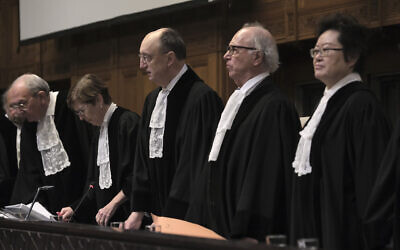 Judges start the second day of hearings at the International Court of Justice in The Hague, Netherlands, Friday, Jan. 12, 2024. The United Nations' top court was hearing South Africa's allegation that Israel's war with Hamas amounts to genocide against Palestinians, a claim that Israel strongly denies. (AP Photo/Patrick Post)