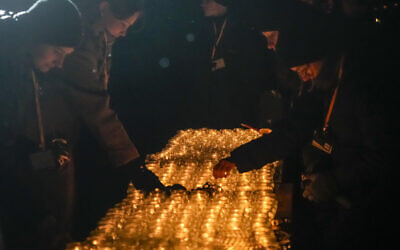 People light candles by the monument at the Birkenau Nazi death camp in Oswiecim, Poland, Saturday, Jan. 27, 2024. (AP/Czarek Sokolowski)