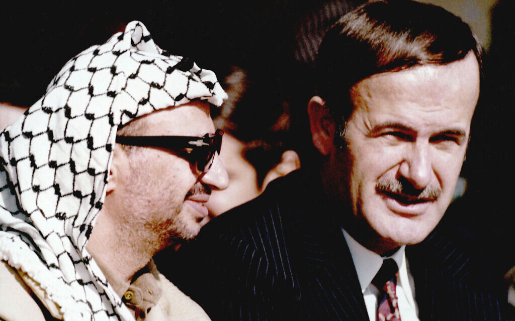 Syria's former president Hafez Assad, right, is pictured beside Yasser Arafat near Damascus, Syria, in December, 1974. (AP Photo)