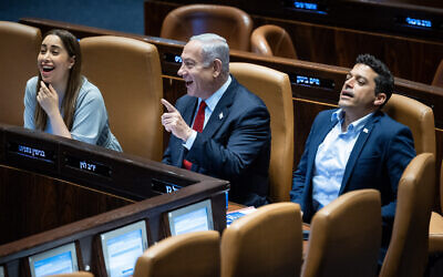 Prime Minister Benjamin Netanyahu (center) sits with Diaspora Affairs Minister Amichai Chikli and Likud Minister May Golan (L) at the Knesset plenum in Jerusalem, on June 26, 2023. (Yonatan Sindel/Flash90)
