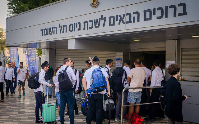 Ultra-Orthodox men who decided to join the IDF amid the ongoing war between Israel and Hamas arrive at the IDF recruiting offices in Tel Hashomer, near Tel Aviv, October 23, 2023. (Avshalom Sassoni/Flash90)
