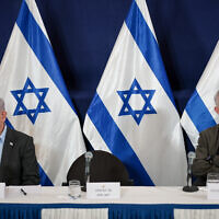 Minister Benny Gantz with Prime Minister Benjamin Netanyahu during a press conference at the Defense Ministry headquarters in Tel Aviv, December 16, 2023. (Noam Revkin Fenton/Flash90)