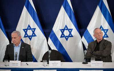 Minister Benny Gantz with Prime Minister Benjamin Netanyahu during a press conference at the Defense Ministry headquarters in Tel Aviv, December 16, 2023. (Noam Revkin Fenton/Flash90)