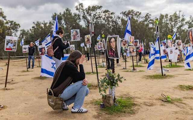 People visit the site of the Supernova music festival massacre in Re'im near the Israeli-Gaza border, January 14, 2024. (Chaim Goldberg/Flash90)