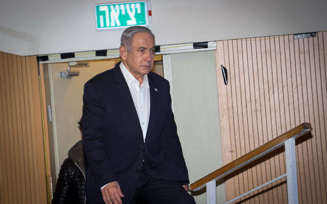 Prime Minister Benjamin Netanyahu arrives to speak at a press conference at the Kiriya military HQ in Tel Aviv on January 18, 2024. (Yariv Katz/POOL)