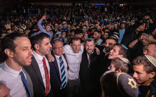 Cabinet ministers and MKs dance during the 'Settlements Bring Security' conference to promote rebuilding Jewish settlements in Gaza at the International Convention Center in Jerusalem, January 28, 2024. (Chaim Goldberg/Flash90)