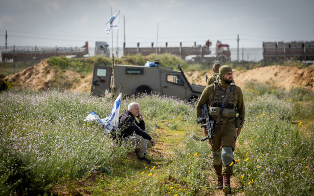 File: Israeli security forces guard while People protest against aid trucks entering the Gaza Strip, at the Kerem Shalom Crossing in southern Israel, January 29, 2024 (Chaim Goldberg/Flash90)