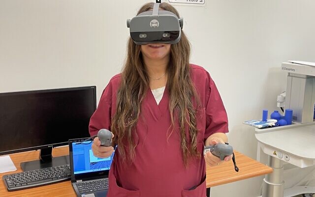 Occupational Therapist Chen Ben Dan demonstrates the XRHealth therapeutic virtual reality system, Sheba Medical Center, December 28, 2023. (Renee Ghert-Zand/Times of Israel)