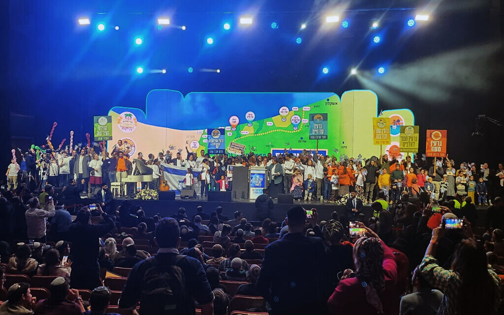 Settlement activists at a conference in Jerusalem to promote the construction of Jewish settlements in Gaza go up on stage in dedicated groups that seek to establish six new settlements in the coastal enclave, January 28, 2024. (Courtesy the Nachala Settlement Movement)
