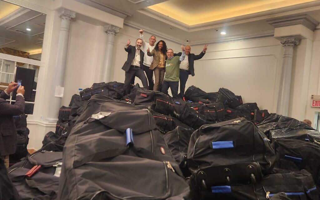 Volunteers in the US packing thousands of pairs of certified, army grade boots into duffle bags to ship and donate to Israeli soldiers during ongoing Hamas war. (Courtesy)