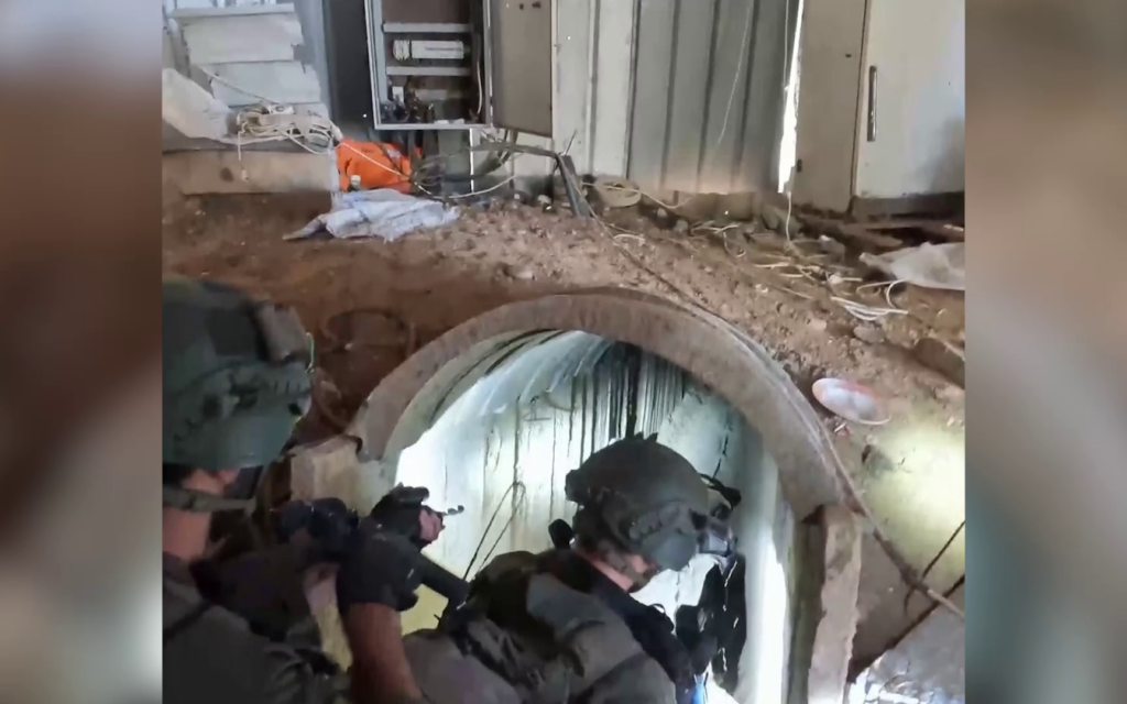 IDF soldiers at the entrance to a Hamas tunnel found in the central Gaza Strip and located just one and a half kilometers from the Israeli border, January 24, 2024. (Screenshot/Israel Defense Forces)