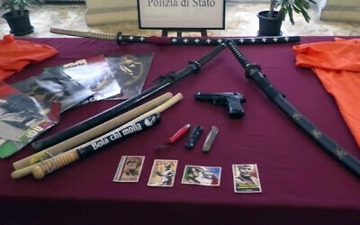 This picture taken from a publicly distributed police video shows some of the items recovered in the homes of 24 people investigated for apology of Fascism in Ferrara, northern Italy, February 14, 2024. (Italian Police via AP)