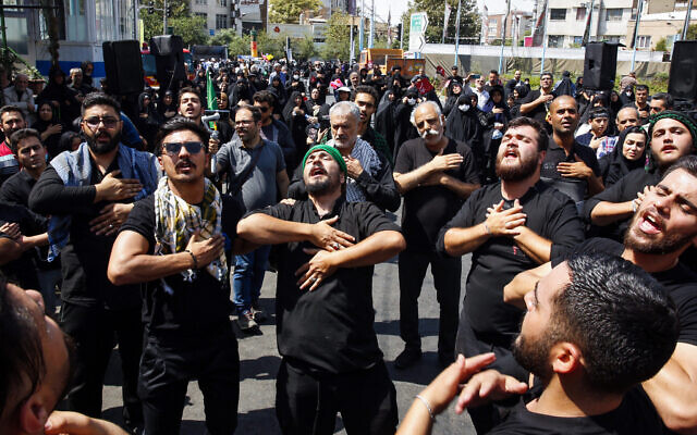Shiite Muslim devotees participate in a mourning procession in Tehran on September 6, 2023, to observe Arbaeen, which marks the end of the 40-day mourning period for the killing of Imam Hussein, a founding figure in Shiite Islam and the grandson of the Prophet Mohammed, by the forces of the caliph Yazid in 680 AD. (Photo by AFP)