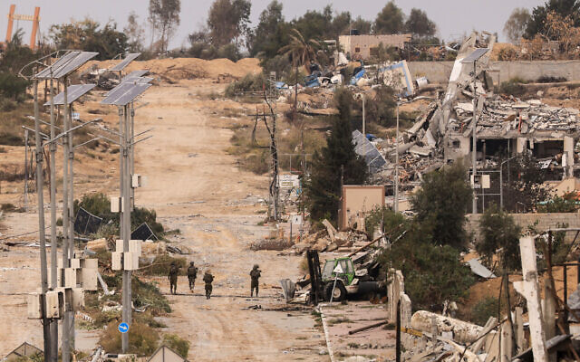Israeli soldiers patrol in Gaza City's Zeitoun neighborhood on November 25, 2023, on the second day of a truce between Israel and Hamas. (Mahmud Hams/AFP)