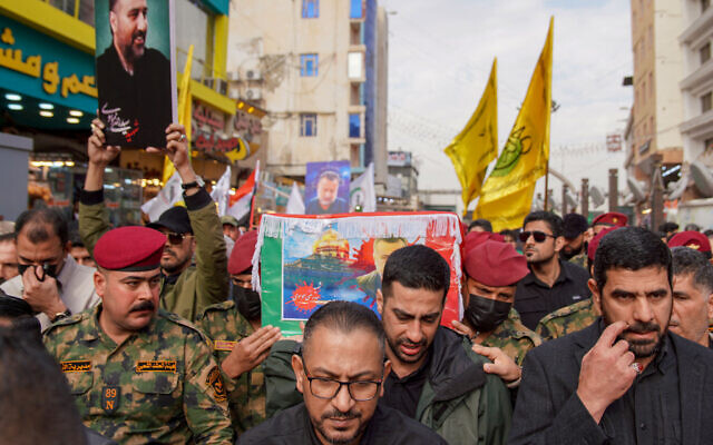 Honor guards carry the coffin of Razi Moussavi, a senior commander in the Quds Force of Iran's Islamic Revolutionary Guard Corps (IRGC), killed on December 25 in an alleged Israeli strike in Syria, during his funeral procession at the Imam Ali shrine in Iraq's holy city of Najaf, on December 27, 2023.(Qassem al-Kaabi / AFP)