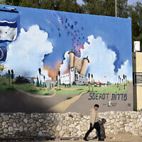 A man walks past the Sderot police station that was attacked by Hamas terrorists on October 7, in the southern Israeli city of Sderot near the Gaza border on January 8, 2024, during ongoing battles between Israel and the Hamas. (Alberto PIZZOLI/AFP)