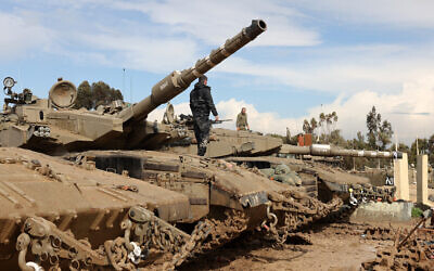 Israeli troops and tanks are stationed along the border with the Gaza Strip on February 2, 2024. (Jack Guez/AFP)