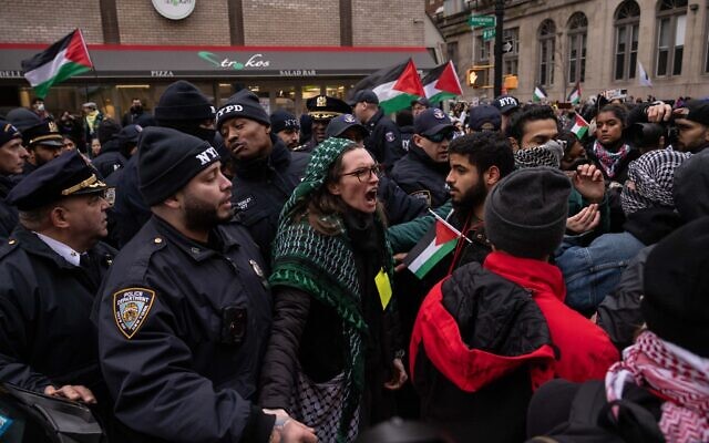 NYPD officers push anti-Israel protesters off the street during the 'All out for Palestine' rally outside Columbia University in New York on February 2, 2024. (Photo by Yuki IWAMURA / AFP)